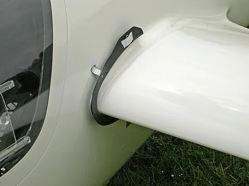 A close view of a device on a white sailplane wing.