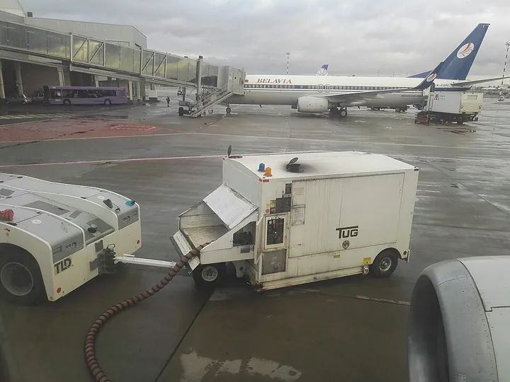 A ground power unit beside a Belavia aircraft at Minsk Airport