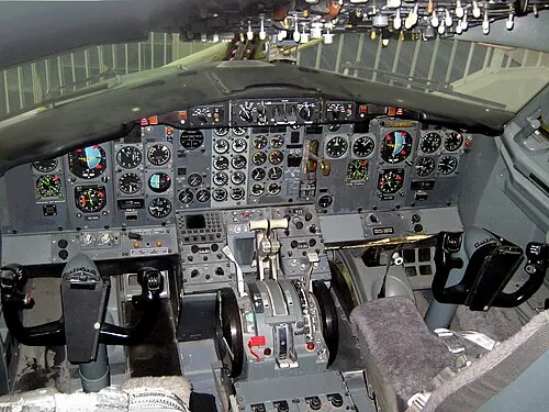An early Boeing 737 cockpit displayed in a museum.