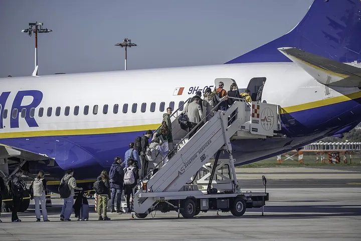 Passengers using rear boarding stairs to enter a Ryanair Boeing 737-800