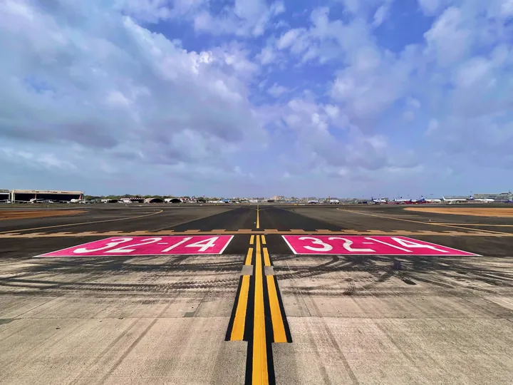 A runway holding-position marking on a taxiway at Mumbai Airport
