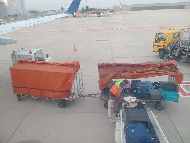 Suitcases being loaded with an aircraft belt loader at Ben Gurion Airport