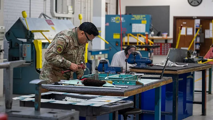 A technician carries out an aircraft structural repair.