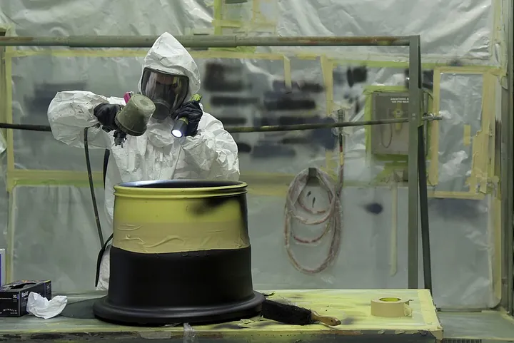 A wheel receives a protective coating in a maintenance shop.