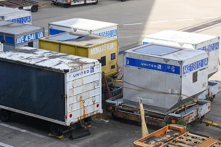 United Airlines baggage containers on dollies at Tokyo Narita Airport