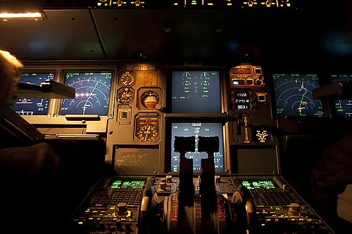 Illuminated displays and controls in an Airbus A320 cockpit.