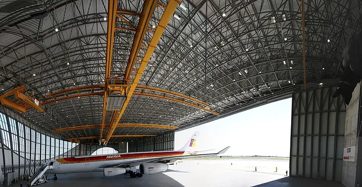An overview shows an airline maintenance hangar.