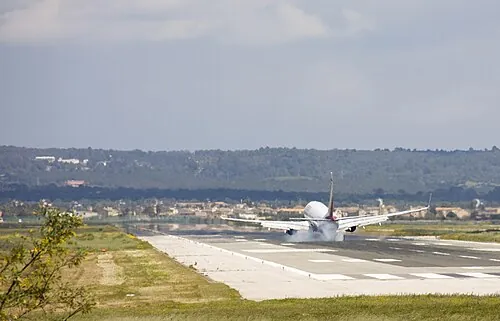 Air Berlin aircraft landing on a runway viewed from near its centerline direction.