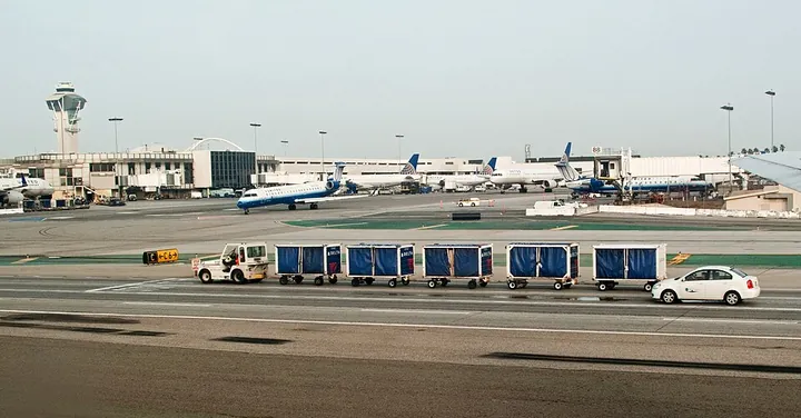 Delta baggage carts on the apron at Los Angeles International Airport
