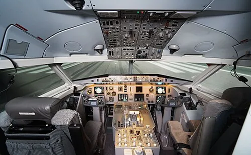 Full-width view of a Fokker 100 simulator cockpit.