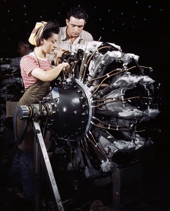 A trainee works on a radial engine at an aircraft factory in 1942.