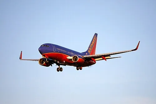 Southwest Boeing 737 with landing gear extended on approach to San Jose.