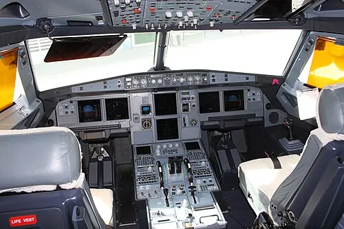 Two pilot seats facing the instrument panel in an Airbus A318.