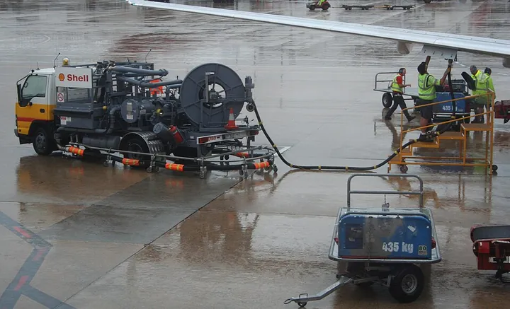 An airport hydrant refuelling vehicle servicing an aircraft