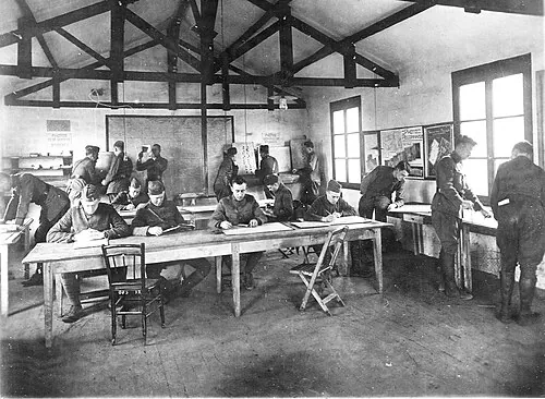 Historical observer-school pupils gathered at classroom work tables.