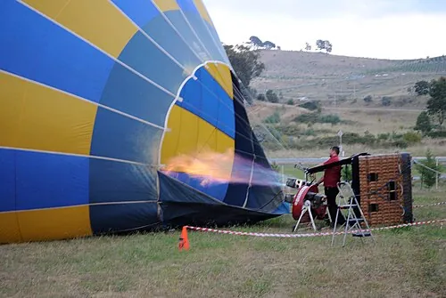 A hot-air balloon being inflated on the ground.