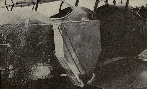 A historical photograph showing a hopper installed on an early crop-dusting aircraft.