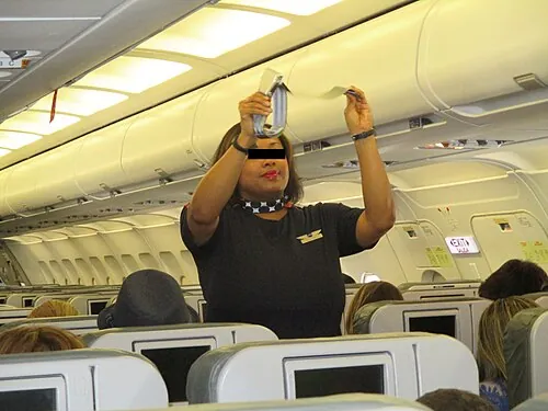A cabin safety demonstration aboard a JetBlue aircraft.