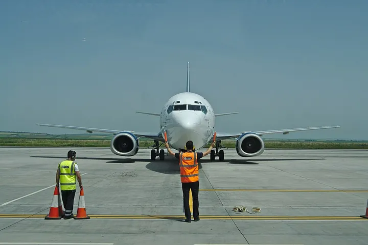 A marshaller signalling an aircraft to stop at Iași International Airport in Romania