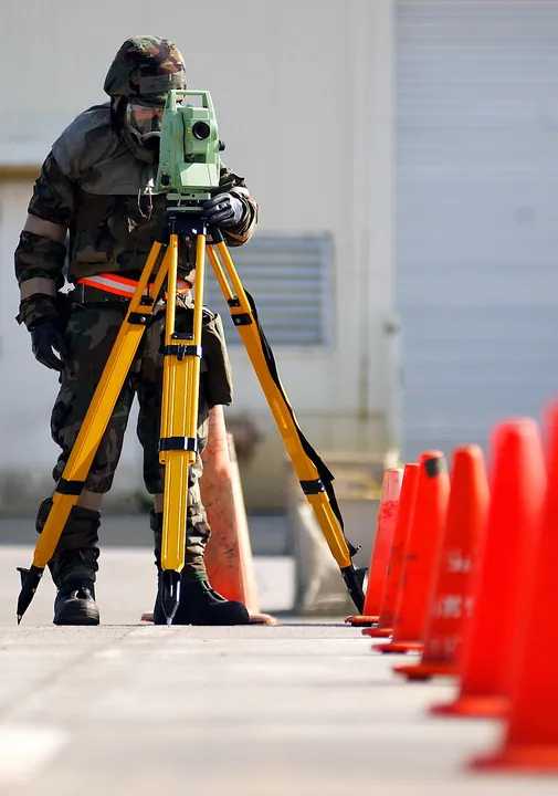 An airman using a theodolite to position PAPI lights during training at Kadena Air Base