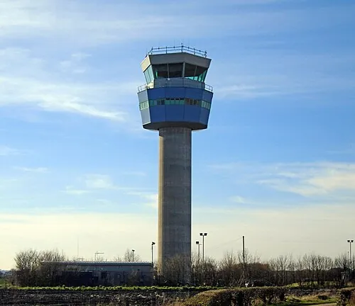 Liverpool John Lennon Airport control tower above a fenced boundary.
