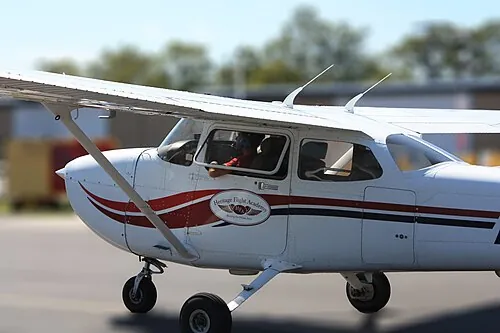 A Cessna 172 seen close-up on the ground after a training flight.