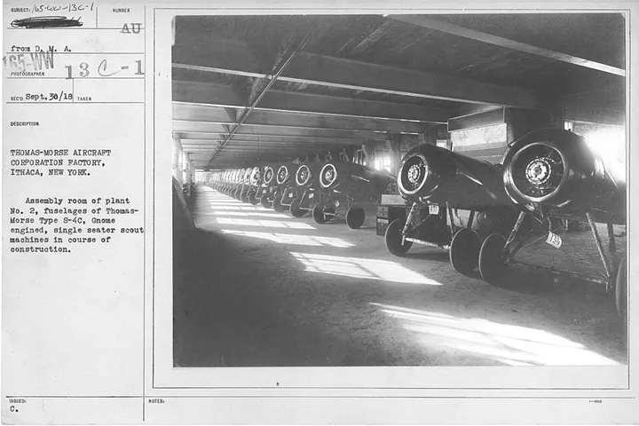 Fuselages are arranged in an early aircraft assembly room.
