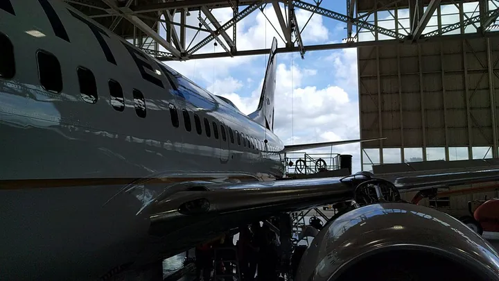 A Boeing 737 is worked on in an airline hangar.