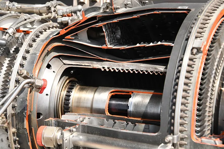 A cutaway view exposes the combustion section of a turbine engine.