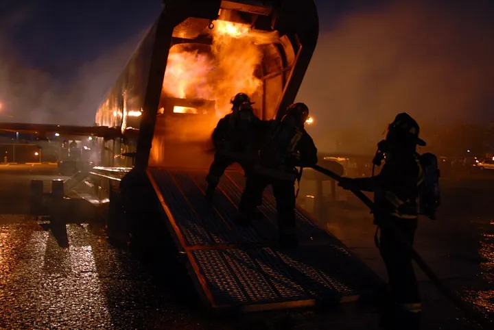 Firefighters practicing with a mobile aircraft-firefighting training device in Hawaii