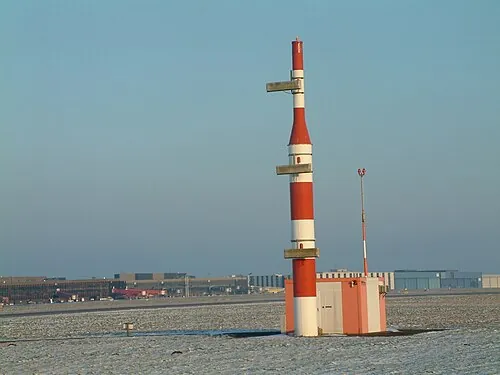 Red-and-white glide-slope mast and equipment building at Hanover Airport.