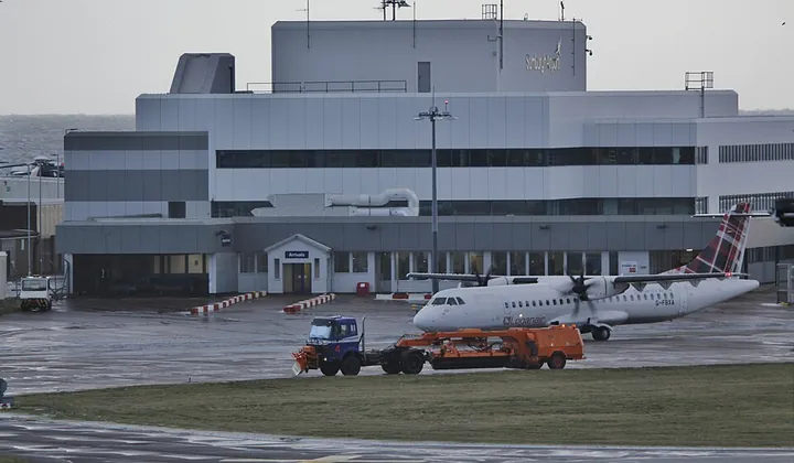 Runway-clearance vehicles working after a light snow shower